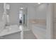 Bright bathroom with a soaking tub, tile flooring, and access to the bedroom at 301 Fayetteville St # 2611, Raleigh, NC 27601