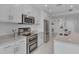 Modern kitchen with stainless steel appliances, granite countertops, and white cabinetry at 301 Fayetteville St # 2611, Raleigh, NC 27601