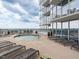 Relaxing rooftop pool area with multiple lounge chairs and stunning city views at 301 Fayetteville St # 2611, Raleigh, NC 27601