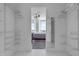 Walk-in closet leading to bedroom with expansive views and a mirrored closet space at 301 Fayetteville St # 2611, Raleigh, NC 27601