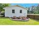 Backyard featuring a fire pit surrounded by seating, and a well-kept lawn at 309 S Mckay Ave, Dunn, NC 28334