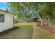 Large backyard featuring a trampoline, a slide and mature trees at 309 S Mckay Ave, Dunn, NC 28334