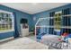 bedroom with blue walls features a house bed and large windows at 309 S Mckay Ave, Dunn, NC 28334