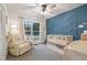 Bedroom features a blue accent wall, a large window, and neutral decor at 309 S Mckay Ave, Dunn, NC 28334