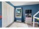 Blue bedroom featuring a closet, gray dresser, blue curtains and a window view at 309 S Mckay Ave, Dunn, NC 28334
