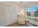 Bedroom features a neutral color palette and large window overlooking the lawn at 309 S Mckay Ave, Dunn, NC 28334