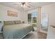 Cozy bedroom featuring a ceiling fan, a mirror and a window view at 309 S Mckay Ave, Dunn, NC 28334