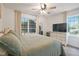 Bright bedroom featuring a ceiling fan and a window view to the exterior at 309 S Mckay Ave, Dunn, NC 28334