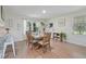 Bright dining room features a wooden table with seating for six, light-colored walls, and wood-look floors at 309 S Mckay Ave, Dunn, NC 28334