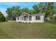 Charming home with a landscaped front yard and beautiful curb appeal, trash cans in the background at 309 S Mckay Ave, Dunn, NC 28334