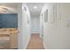 Hallway with wood-look floors leads to a bedroom with a blue accent wall at 309 S Mckay Ave, Dunn, NC 28334
