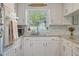 Bright kitchen with subway tile, granite countertops, stainless steel appliances, and a window at 309 S Mckay Ave, Dunn, NC 28334