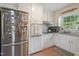 Bright kitchen features white cabinets, subway tile backsplash, stainless steel appliances, and granite countertops at 309 S Mckay Ave, Dunn, NC 28334
