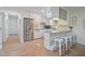 Bright kitchen with white cabinets, granite countertops, stainless steel appliances, and breakfast bar at 309 S Mckay Ave, Dunn, NC 28334