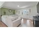 Bright and open living room with stylish green accent wall and comfortable sectional sofa at 309 S Mckay Ave, Dunn, NC 28334