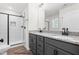 Modern bathroom with double vanity, granite countertop, and glass-enclosed shower at 325 Bluejay St, Clayton, NC 27520