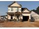 Exterior shot of new construction home featuring brick foundation and attached garage at 325 Bluejay St, Clayton, NC 27520
