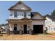 New two-story home featuring a brick pillar front porch and attached two car garage under construction at 325 Bluejay St, Clayton, NC 27520