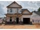 New two-story home under construction features a front porch with brick supports and an attached two-car garage at 325 Bluejay St, Clayton, NC 27520
