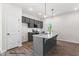 Modern kitchen with stainless steel appliances, gray cabinets, granite countertops and island at 325 Bluejay St, Clayton, NC 27520