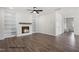 Spacious living room featuring a fireplace, built-in shelving, and wood floors at 325 Bluejay St, Clayton, NC 27520