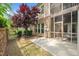 Exterior backyard showcasing a screened patio with brickwork and a manicured lawn at 329 Castle Rock Ln, Cary, NC 27519