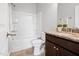 Bathroom featuring granite countertops, dark wood cabinets and a shower-tub combo at 329 Castle Rock Ln, Cary, NC 27519