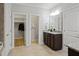 Bathroom featuring a vanity with granite countertops, with access to closets at 329 Castle Rock Ln, Cary, NC 27519
