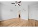 Bright bedroom featuring hardwood floors, white walls, and access to an ensuite bathroom and closet at 329 Castle Rock Ln, Cary, NC 27519