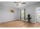 A bright and airy bedroom featuring hardwood floors and a ceiling fan at 329 Castle Rock Ln, Cary, NC 27519