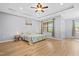 Spacious main bedroom featuring hardwood floors, tray ceilings, and a ceiling fan at 329 Castle Rock Ln, Cary, NC 27519