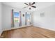 Bright bedroom featuring hardwood floors, natural light from two windows, and a ceiling fan at 329 Castle Rock Ln, Cary, NC 27519