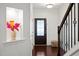Bright foyer with hardwood floors, staircase, and decorative niche with floral arrangement at 329 Castle Rock Ln, Cary, NC 27519