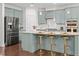Modern kitchen with granite countertops, stainless steel appliances, and bar seating at 329 Castle Rock Ln, Cary, NC 27519