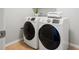 Laundry room featuring white, front-load washer and dryer units with tile flooring at 329 Castle Rock Ln, Cary, NC 27519