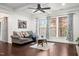 Spacious living room featuring tray ceiling, large windows and hardwood flooring at 329 Castle Rock Ln, Cary, NC 27519
