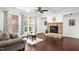 Cozy living room with stone fireplace, large windows, coffered ceiling, and hardwood flooring at 329 Castle Rock Ln, Cary, NC 27519