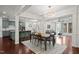 Open-concept living and dining area with hardwood floors, modern lighting, and stylish furnishings at 329 Castle Rock Ln, Cary, NC 27519