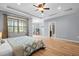 Spacious main bedroom featuring hardwood floors, tray ceilings, and an ensuite bathroom at 329 Castle Rock Ln, Cary, NC 27519