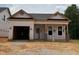 New construction home featuring a modern design, large garage and covered front porch at 335 Bluejay St, Clayton, NC 27520