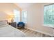 Inviting bedroom features natural light, wood floors, and a cozy blue chair at 358 Tillamook Dr, Wake Forest, NC 27587