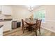 Dining room with hardwood floors, dining table and chairs, a chandelier and lots of natural light at 358 Tillamook Dr, Wake Forest, NC 27587