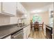 Efficient kitchen layout featuring white cabinets, modern appliances, and hardwood floors at 358 Tillamook Dr, Wake Forest, NC 27587