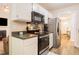 Efficient kitchen layout featuring white cabinets, modern appliances, and hardwood floors at 358 Tillamook Dr, Wake Forest, NC 27587