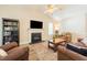 Bright living room featuring a fireplace, vaulted ceiling, comfortable seating, and a ceiling fan at 358 Tillamook Dr, Wake Forest, NC 27587