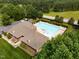 Aerial view of a community pool and clubhouse surrounded by lush landscaping and trees in a residential neighborhood at 3587 Garner Terrace Way, Wake Forest, NC 27587