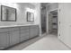 Bathroom featuring double vanity with granite countertops, modern cabinets, walk-in shower, and walk-in closet at 3587 Garner Terrace Way, Wake Forest, NC 27587