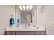 Bright bathroom featuring a vanity with a large mirror, elegant lighting, and stylish decor creating a serene atmosphere at 3587 Garner Terrace Way, Wake Forest, NC 27587