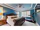 Bedroom with blue walls, a large bed, and a treadmill at 3587 Garner Terrace Way, Wake Forest, NC 27587