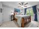 Bedroom featuring a wooden bed frame, gray walls, carpet floors, ceiling fan, and blue curtains at 3587 Garner Terrace Way, Wake Forest, NC 27587